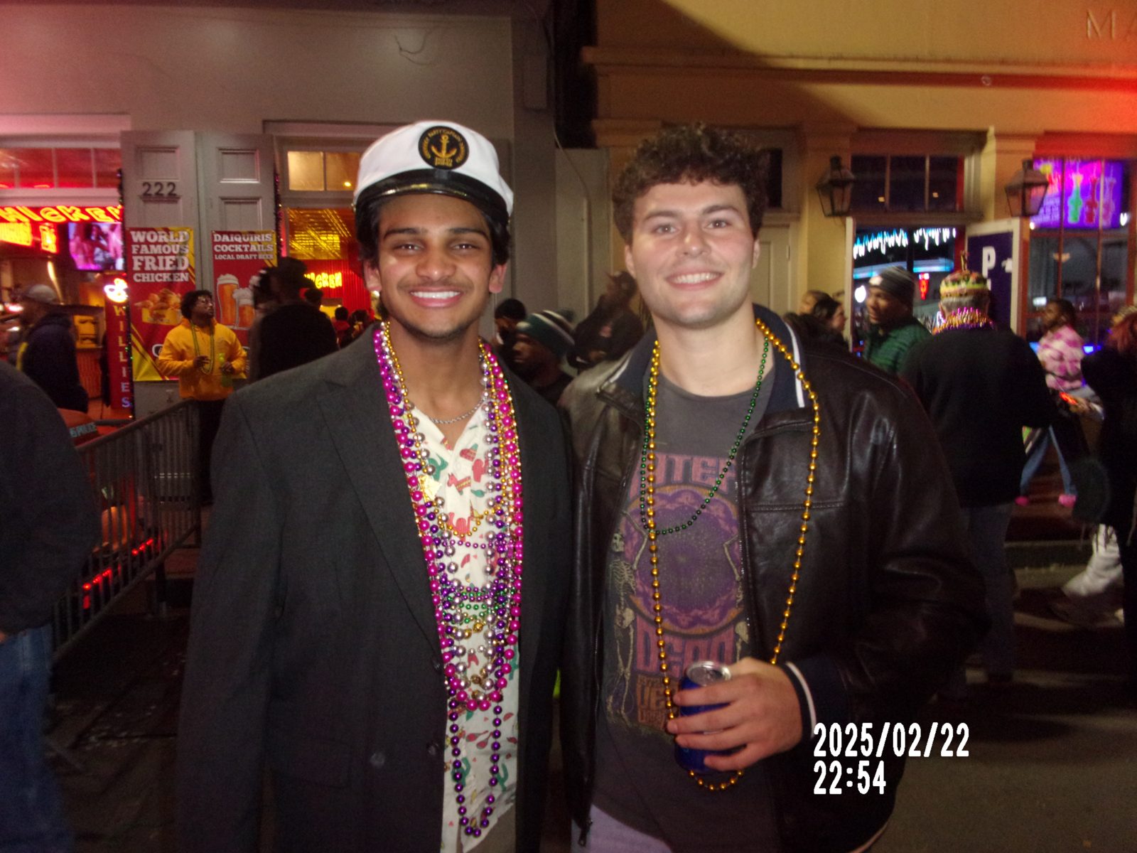 Two friends wearing Mardi Gras beads